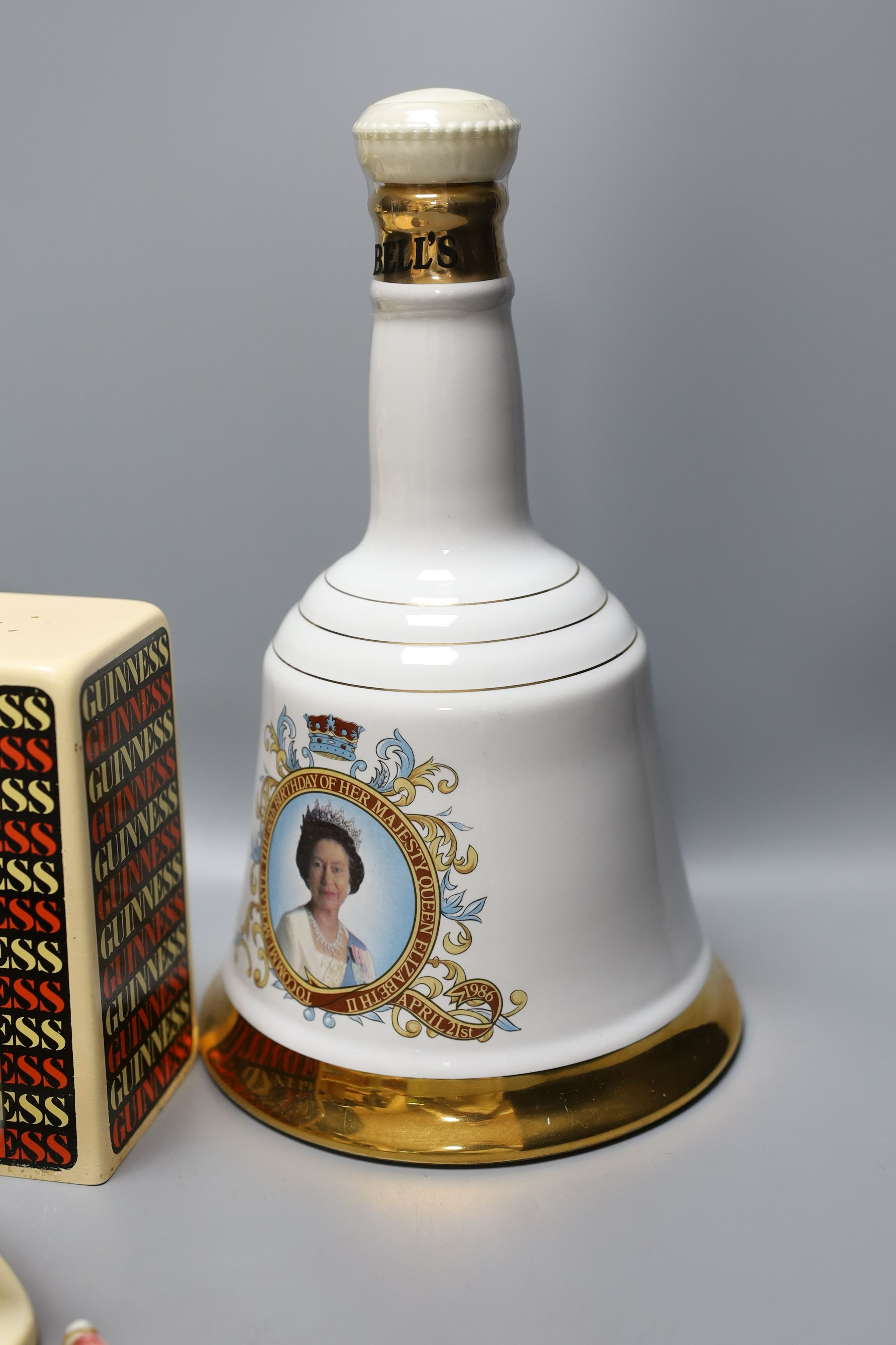 Assorted Guiness memorabilia, a Bells porcelain bottle of whisky, commemorative to the 60th birthday of Her Majesty Queen Elizabeth II